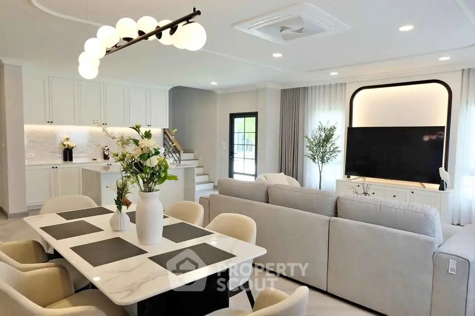 Luxurious open-plan living room with modern decor and elegant dining area