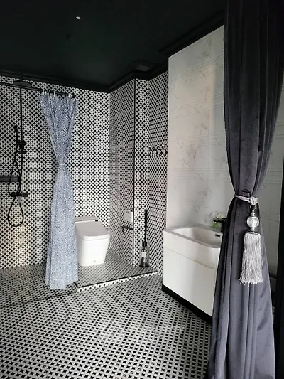 Elegant modern bathroom with stylish black and white tile design and luxurious fixtures.
