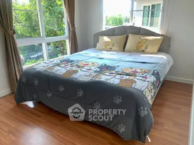 Charming bedroom with large windows and cozy dog-themed bedding, perfect for pet lovers.