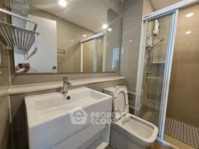 Modern bathroom with sleek fixtures and glass shower enclosure