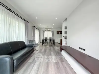Spacious modern living room with elegant dining area and large windows