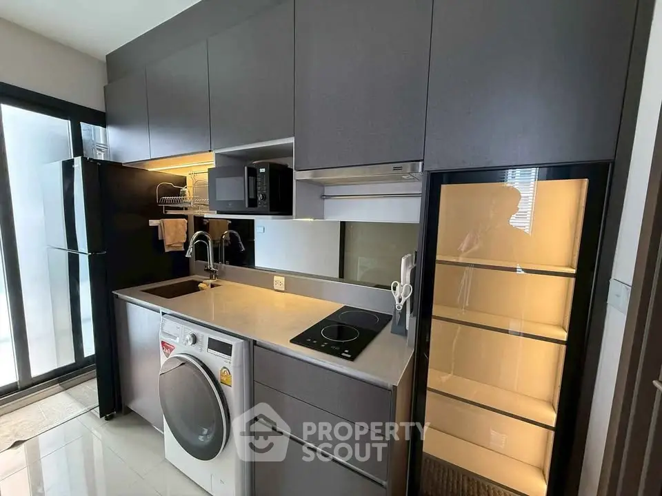 Modern kitchen with sleek cabinetry, built-in appliances, and ample storage space.