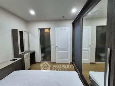 Modern bedroom with sleek furniture and ample storage space