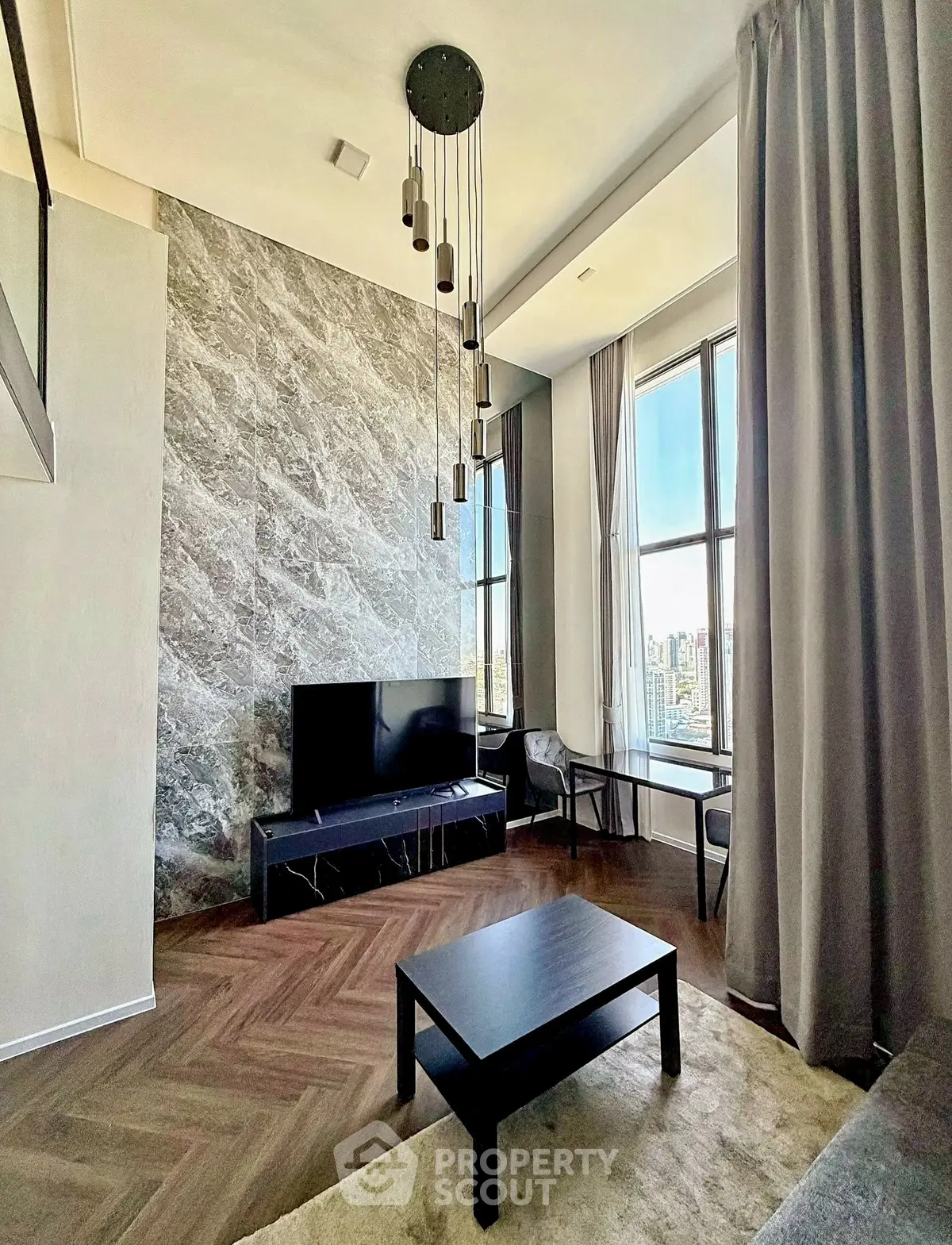 Luxurious living room with high ceilings, modern decor, and city view.