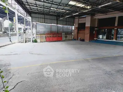 Spacious commercial parking area with covered roof and street access, ideal for business use.
