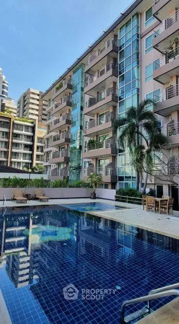 Luxurious apartment building with stunning pool and modern architecture