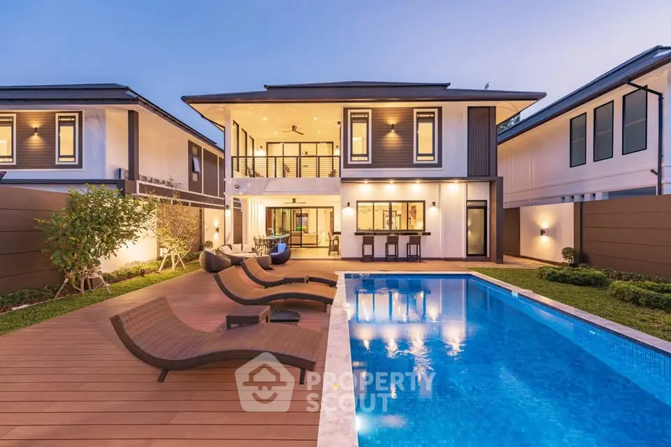 Luxurious modern home with pool and elegant outdoor seating at dusk, perfect for upscale living.