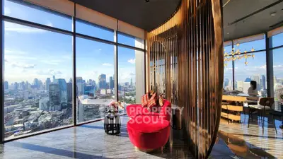 Luxurious high-rise living room with panoramic city views and elegant modern decor.