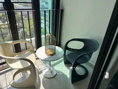 Chic balcony with modern chairs and a birdcage, offering a serene urban view.