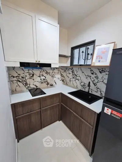 Modern kitchen with marble backsplash and sleek black sink