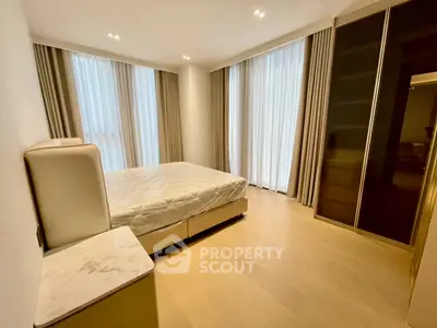 Spacious modern bedroom with large windows and elegant furnishings