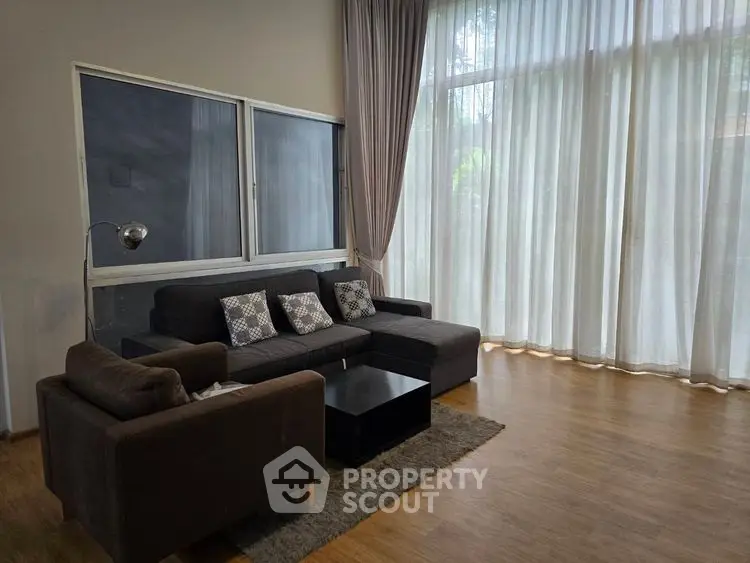 Spacious living room with modern furniture and large windows for natural light.