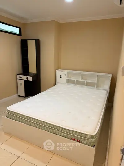 Cozy bedroom with a comfortable bed and stylish furniture, perfect for relaxation.
