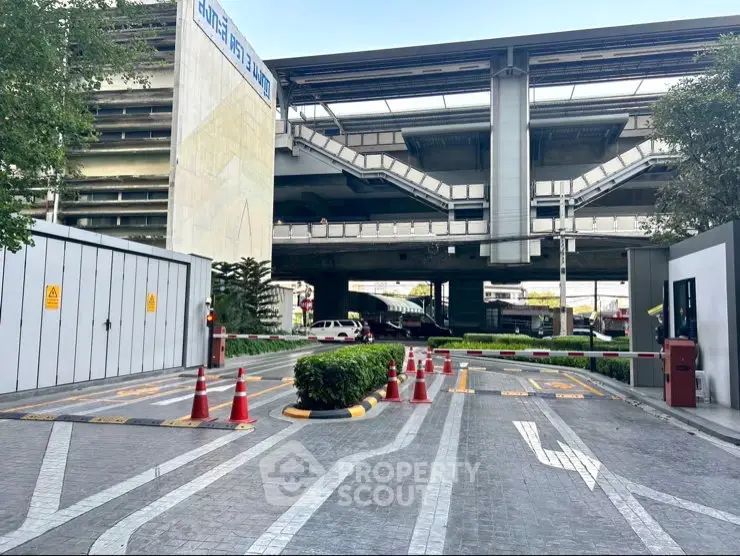 Modern parking area with clear markings and security barriers in urban setting.