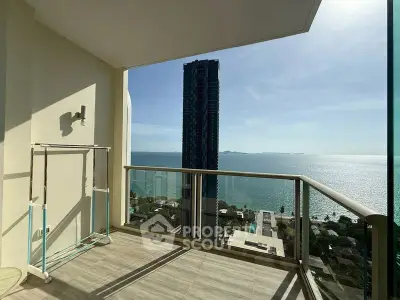 Stunning high-rise balcony with breathtaking ocean view and modern glass railing.