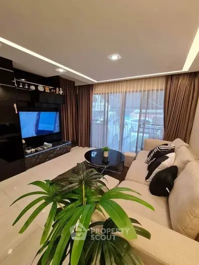 Luxurious living room with modern decor and large windows offering natural light.