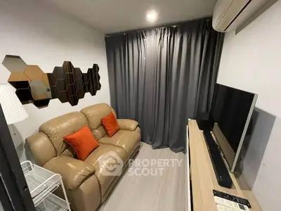Cozy living room with modern decor, leather sofa, and flat-screen TV, perfect for relaxation.