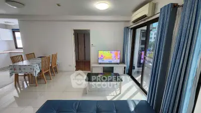 Spacious living room with modern decor and large windows offering natural light.