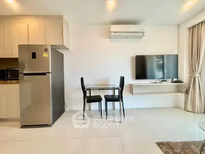 Modern living room with sleek furniture and wall-mounted TV in a stylish apartment.
