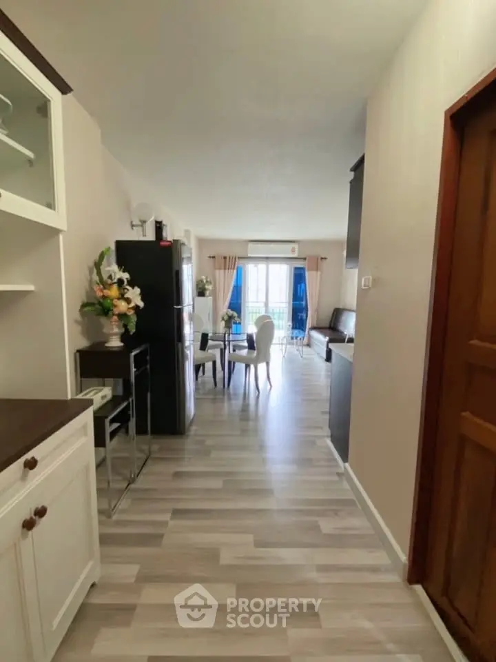 Spacious open-plan living room with modern decor and natural light