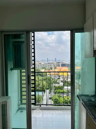 Spacious apartment balcony with stunning city skyline view, perfect for urban living enthusiasts.