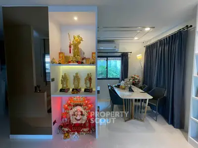 Modern living room with elegant dining area and decorative shelves in a stylish home interior.