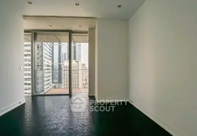 Spacious modern apartment with stunning city view and large balcony access.