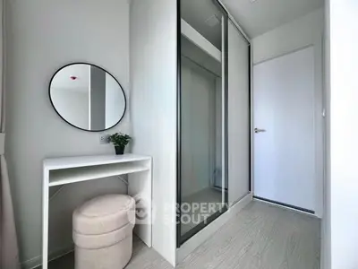 Modern minimalist bedroom with mirrored closet and vanity desk