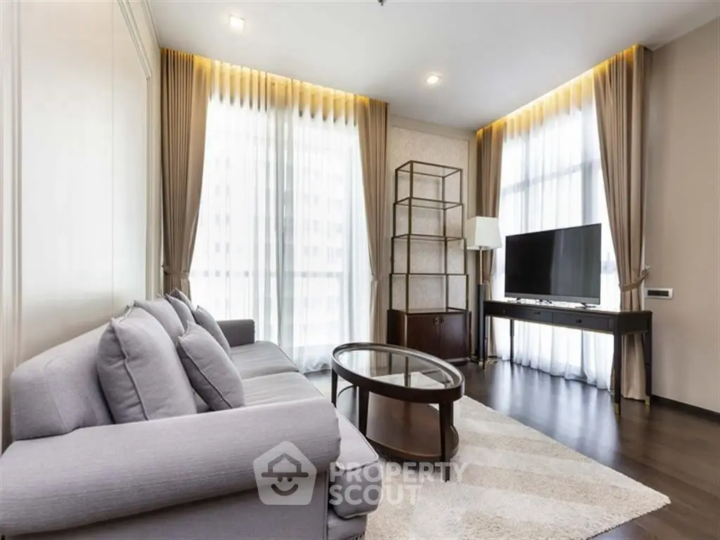 Elegant living room with modern decor, large windows, and stylish furniture.