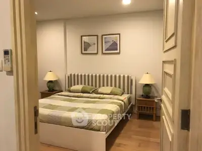 Cozy bedroom with stylish decor and wooden flooring, perfect for relaxation and comfort.