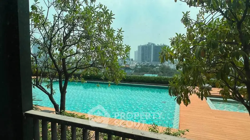 Luxurious rooftop pool with stunning city views and lush greenery, perfect for relaxation and leisure.