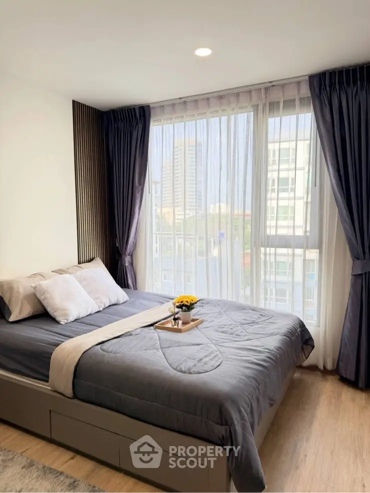 Modern bedroom with large windows and stylish decor in urban apartment
