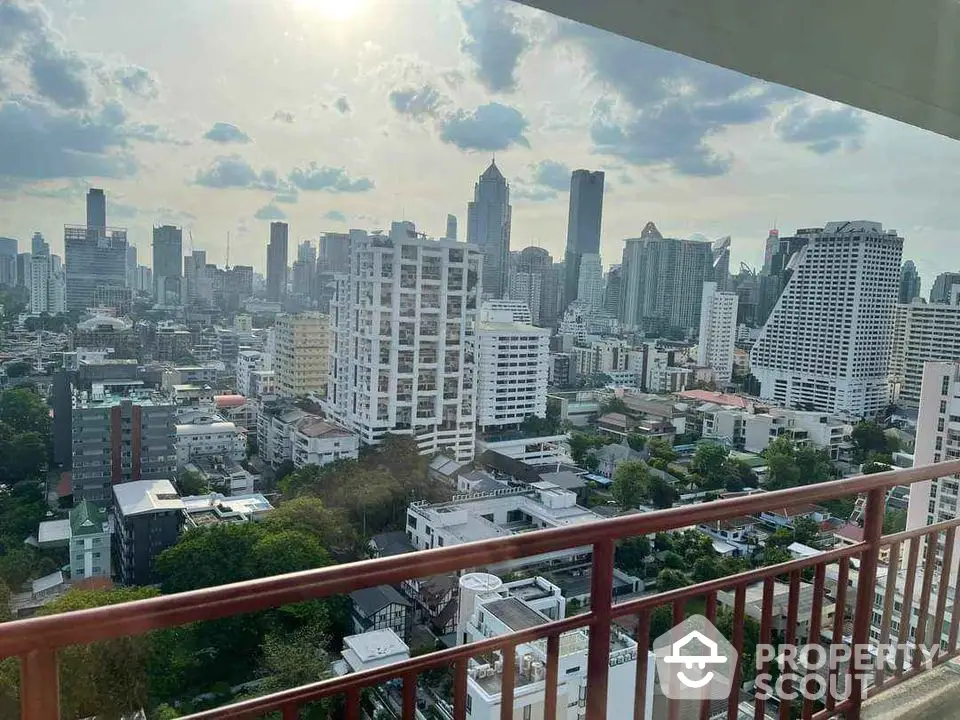 Stunning cityscape view from a high-rise balcony overlooking urban skyline.