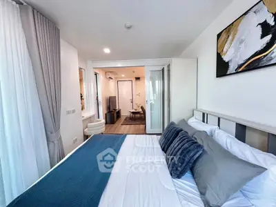 Modern bedroom with stylish decor and open view to living area