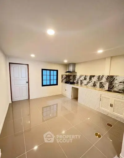 Modern kitchen with sleek marble backsplash and glossy tile flooring