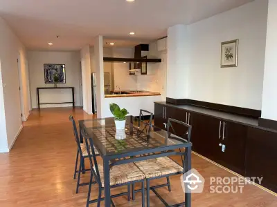 Spacious dining area with modern decor and open kitchen layout in a stylish apartment.