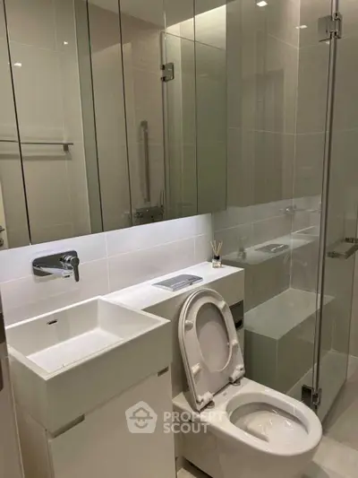 Modern bathroom with sleek fixtures and glass shower enclosure