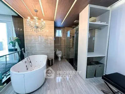 Luxurious bathroom with elegant chandelier and modern bathtub