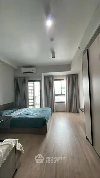 Spacious bedroom with modern decor and natural light
