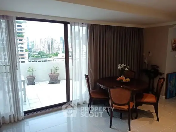 Elegant dining area with city view from balcony, featuring classic furniture and large windows.