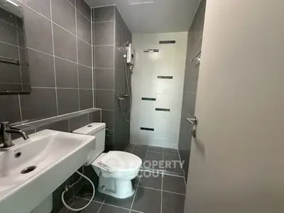 Modern bathroom with sleek gray tiles and compact design