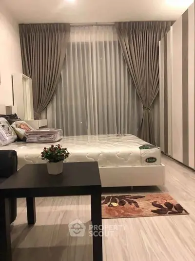 Modern bedroom with elegant curtains and stylish furniture in a cozy apartment.