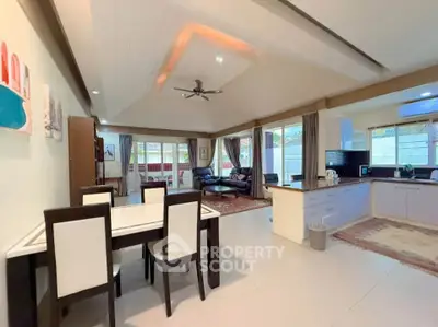 Spacious open-plan living and dining area with modern kitchen and ample natural light.
