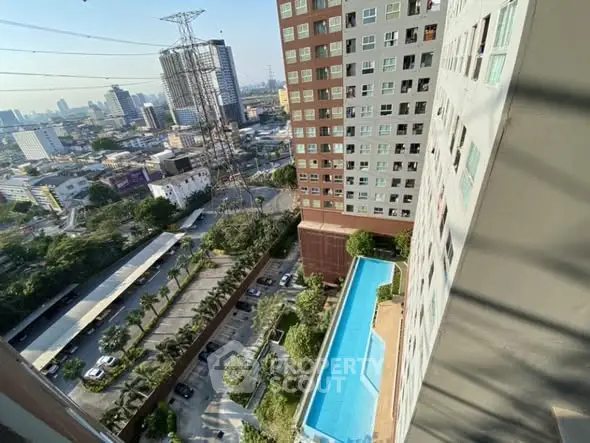 High-rise building with pool and city view from balcony