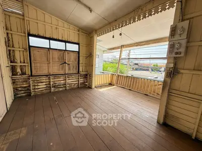 Charming rustic balcony with wooden flooring and vintage details, perfect for relaxation.