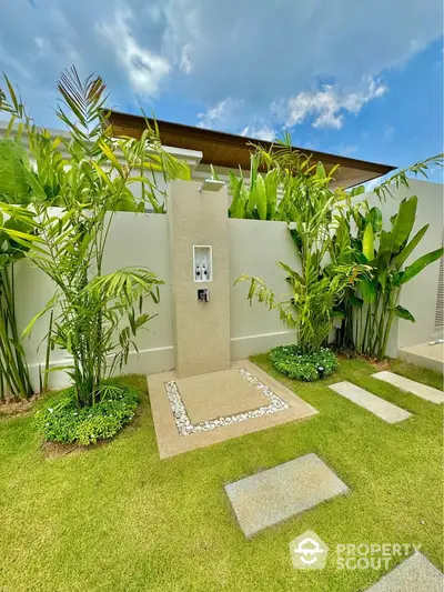 Luxurious outdoor garden shower with lush greenery and modern design