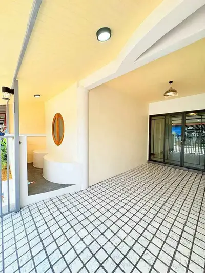 Modern covered balcony with stylish lighting and tiled flooring