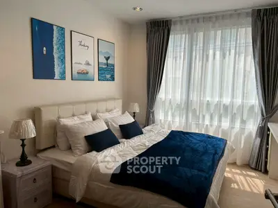 Cozy bedroom with elegant decor and large window for natural light