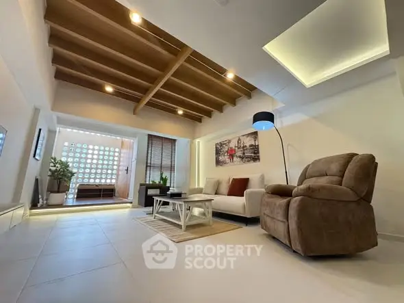 Spacious modern living room with stylish ceiling and cozy seating area.