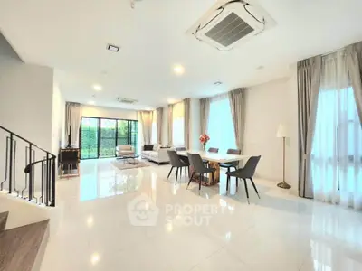 Spacious modern living room with elegant dining area and large windows